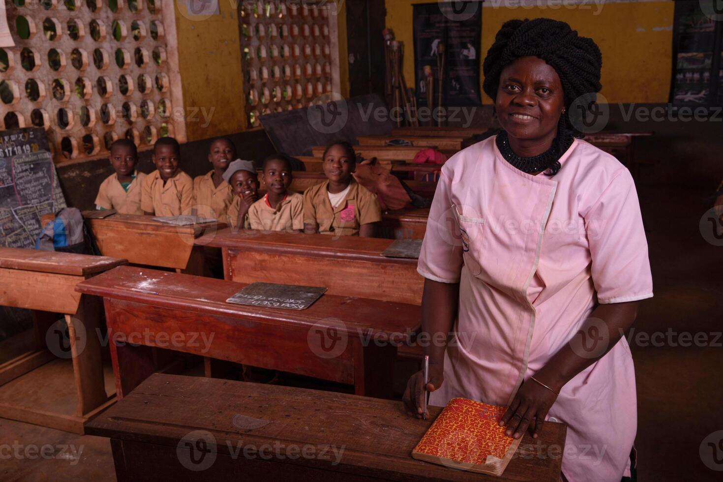 African female teacher in the foreground in the classroom during the lesson photo