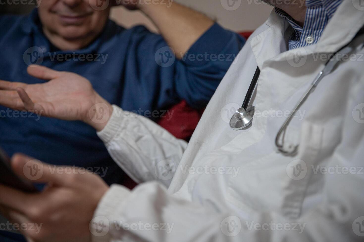Close-up of a doctor's stethoscope during a visit with an elderly patient photo