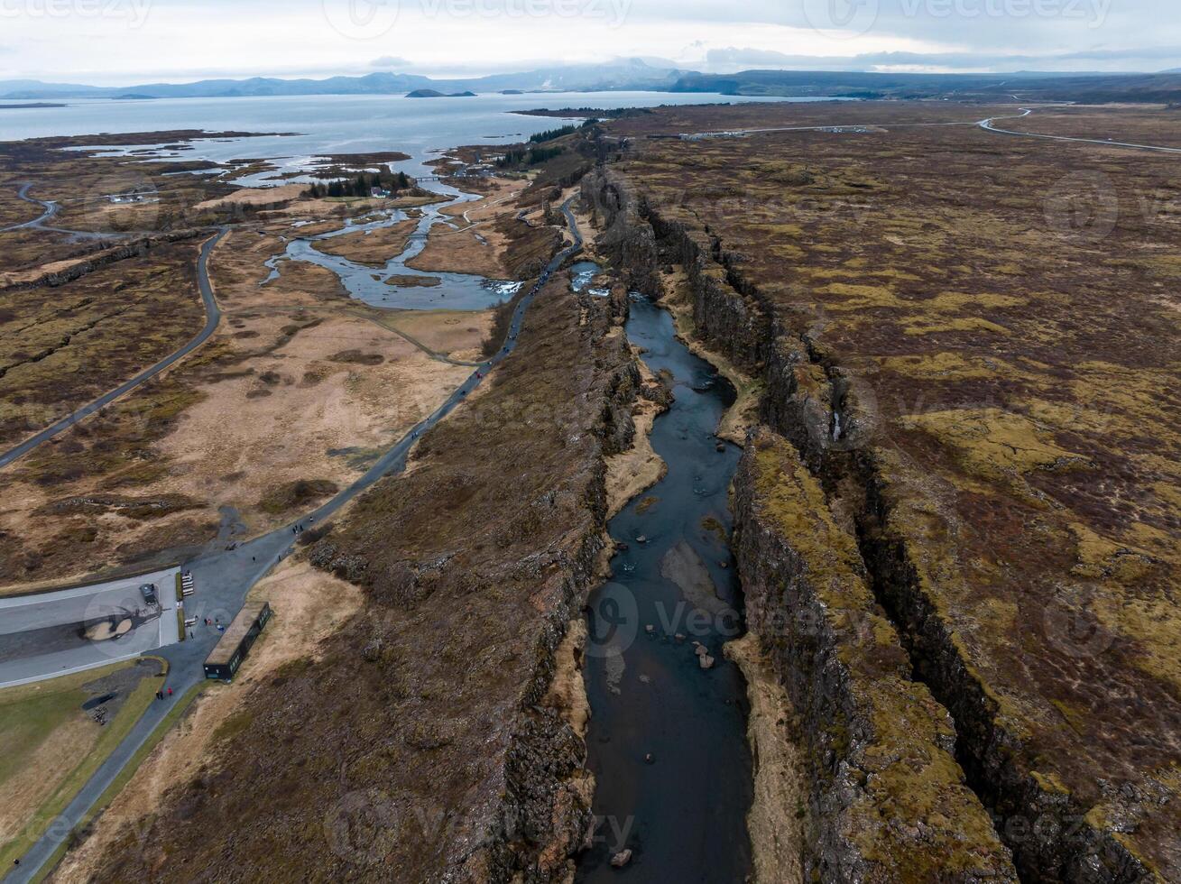 Aerial panorama of Oxarafoss waterfalls in Thingvellir National Park, Iceland, featuring the scenic Oxara River and the unique landscape created by the tectonic plates of America and Eurasia. photo