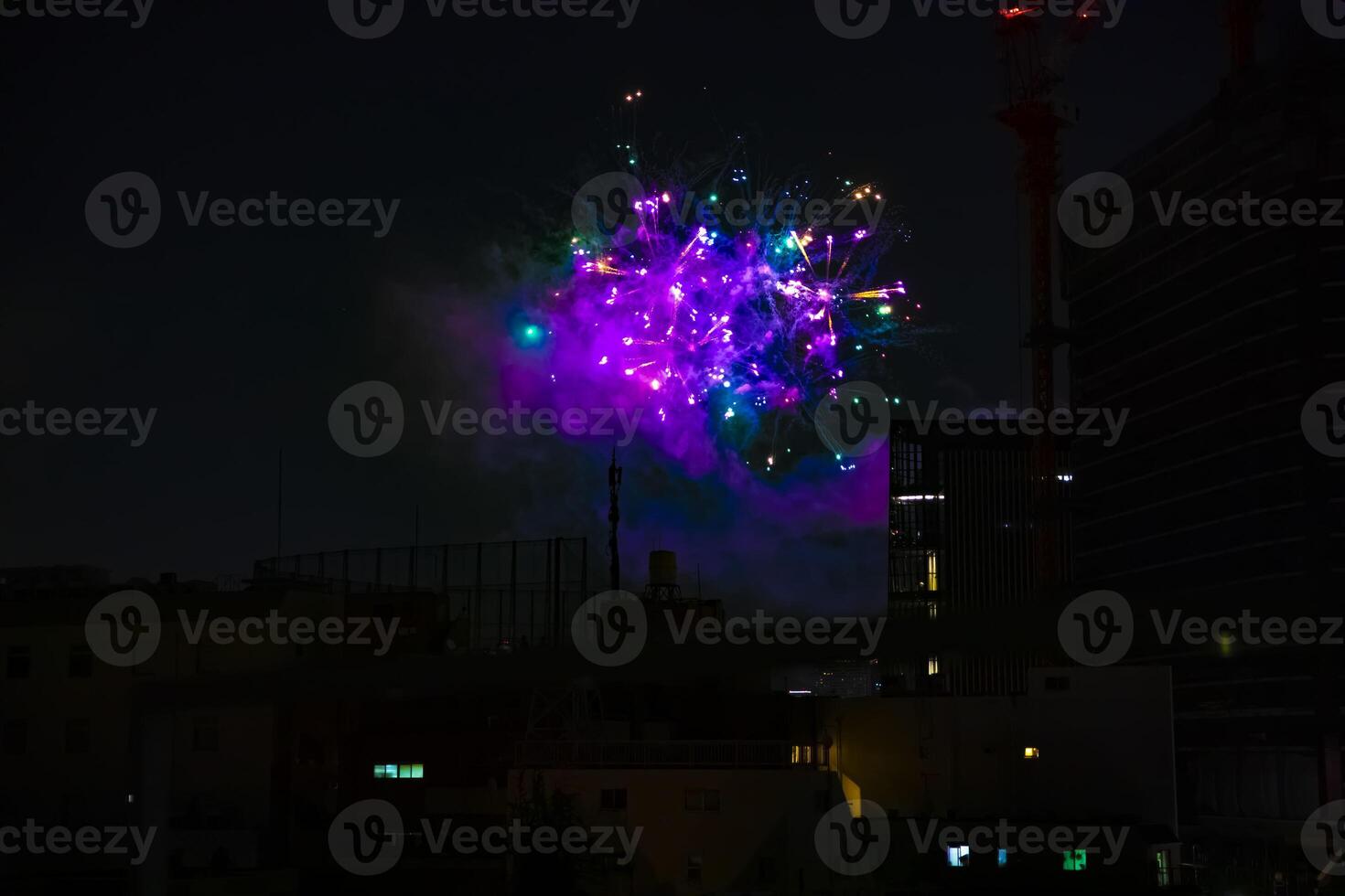 Fireworks near the building at the urban city in Tokyo at summer night photo