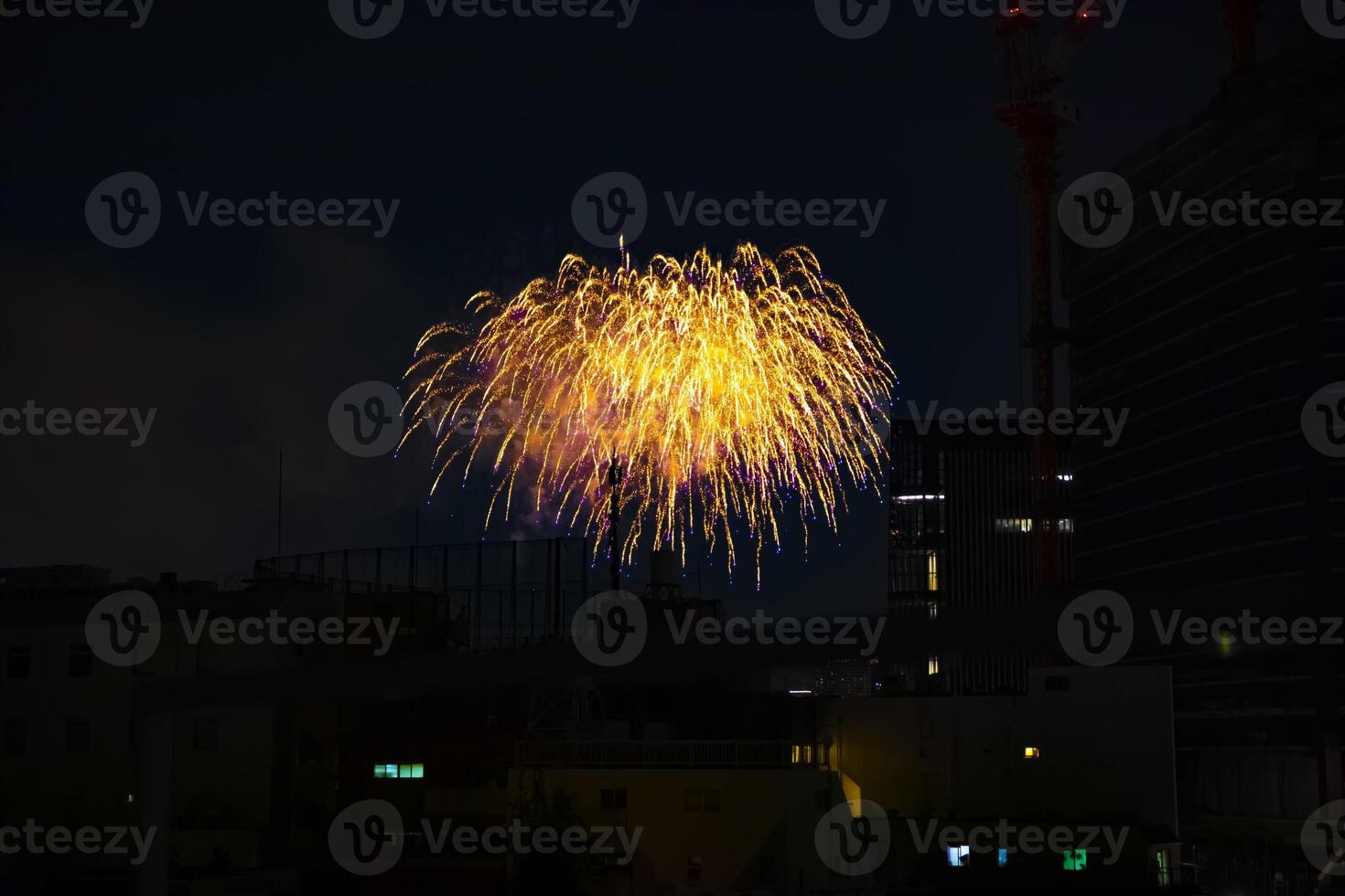 Fireworks near the building at the urban city in Tokyo at summer night photo