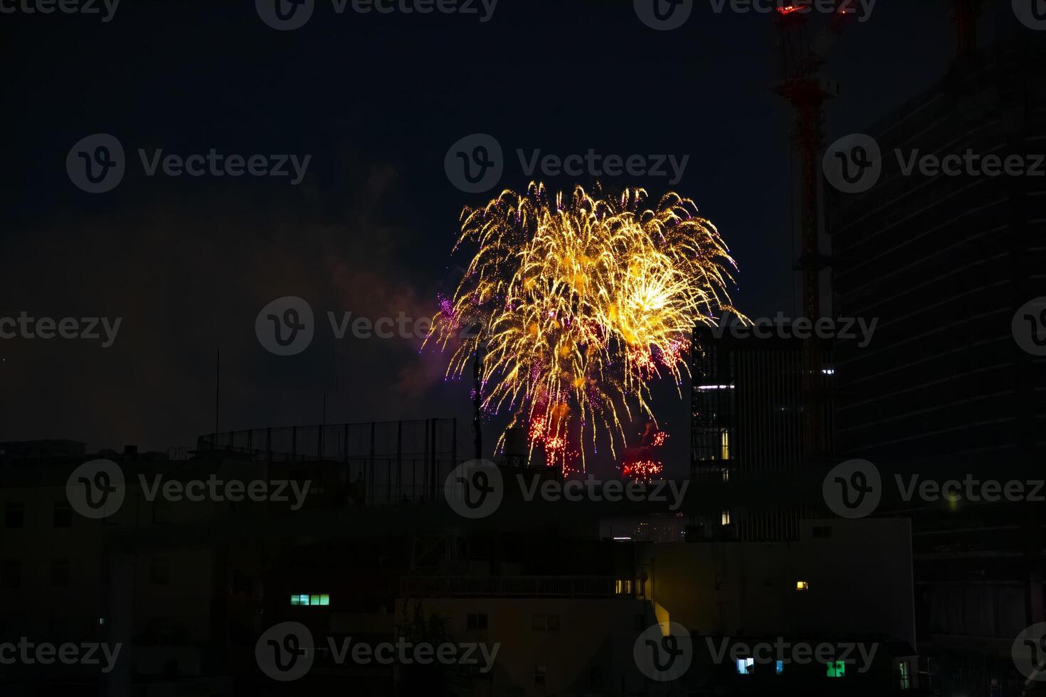 Fireworks near the building at the urban city in Tokyo at summer night photo