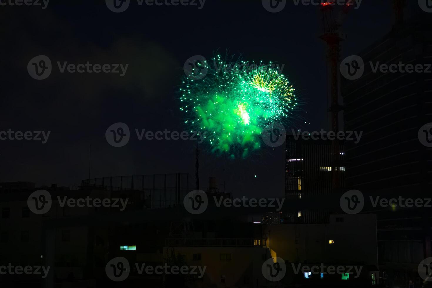 Fireworks near the building at the urban city in Tokyo at summer night photo
