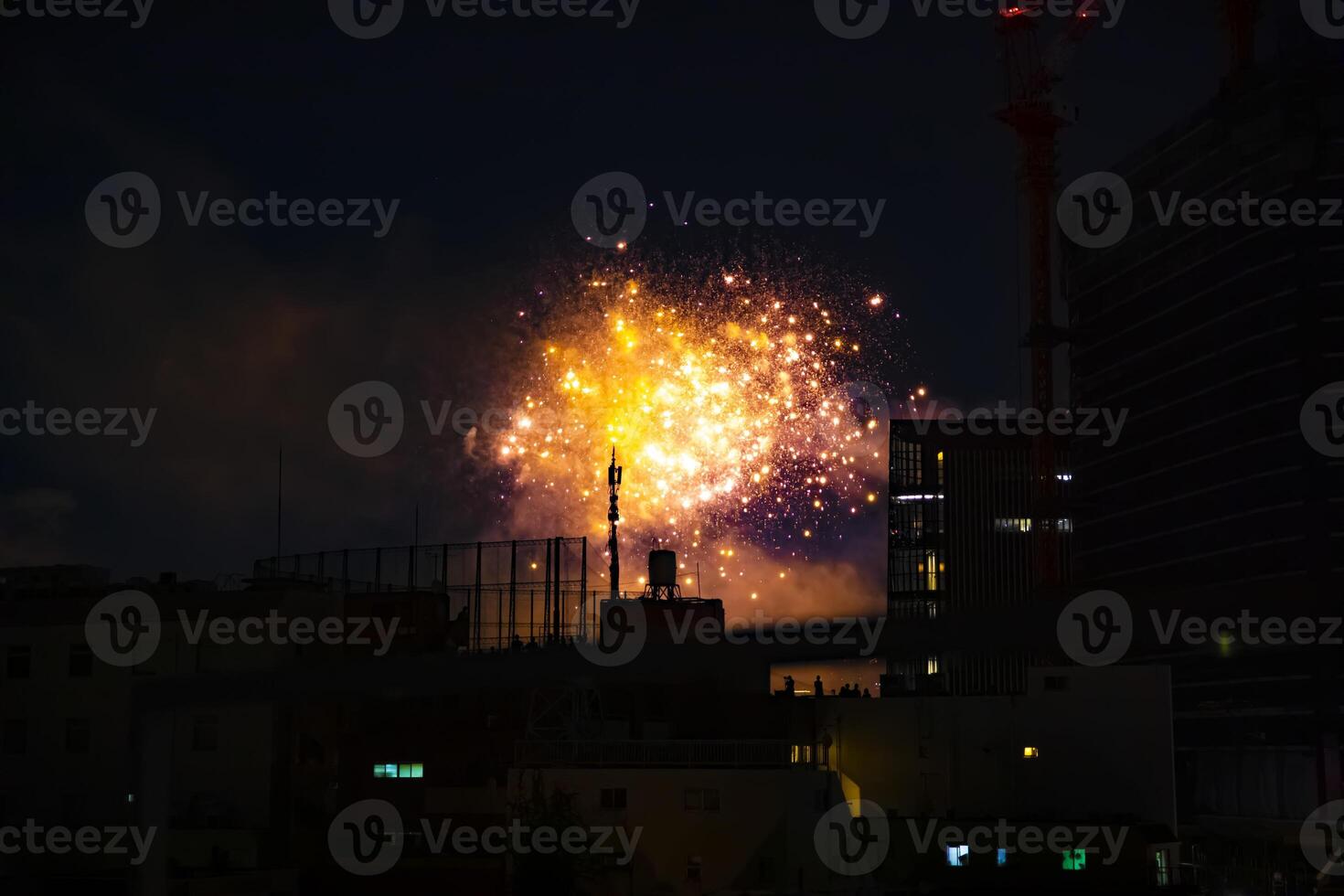 Fireworks near the building at the urban city in Tokyo at summer night photo