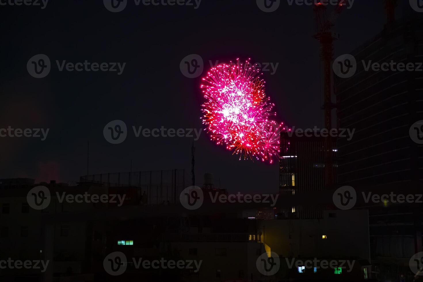Fireworks near the building at the urban city in Tokyo at summer night photo