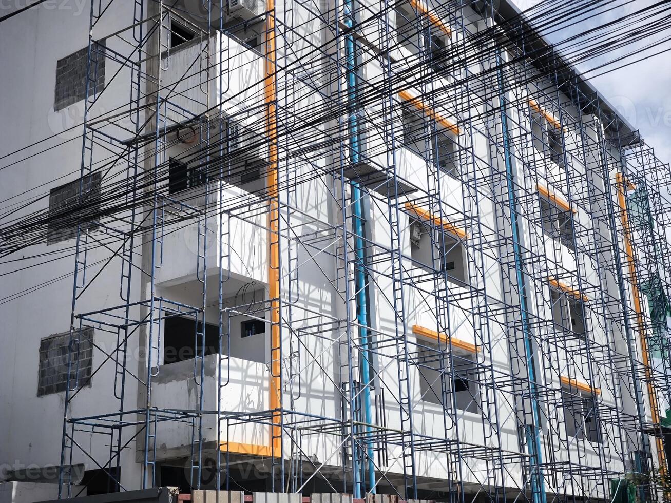 building under construction. scaffolding on building facade. photo