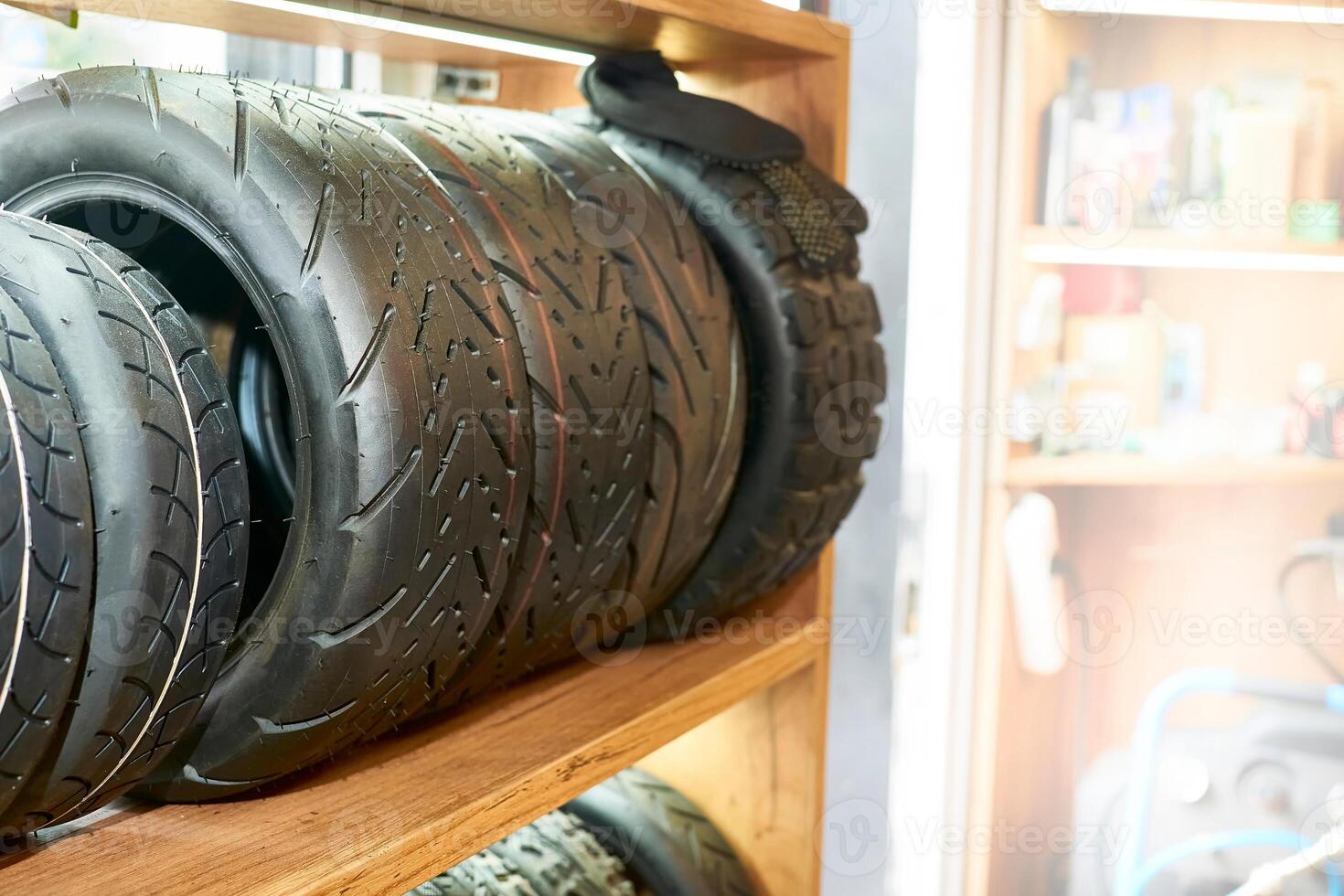 Scooter tires stacked on a shelf in a repair shop store photo