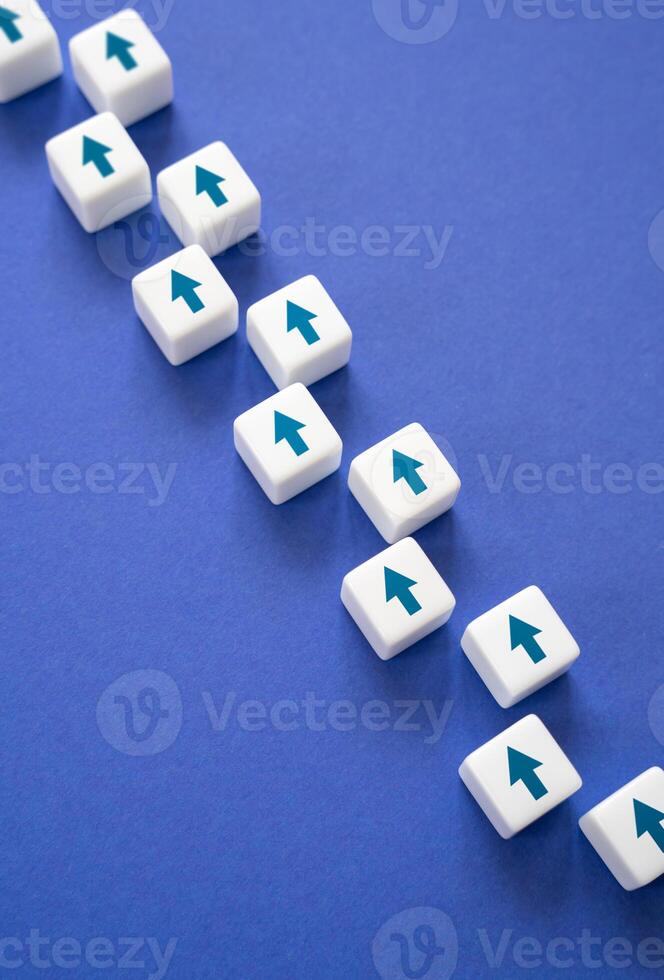 Blocks with arrows laid out in a directional chain. Path and progress. Progress. Life path. Conceptually, minimalism. Mind your own business. photo