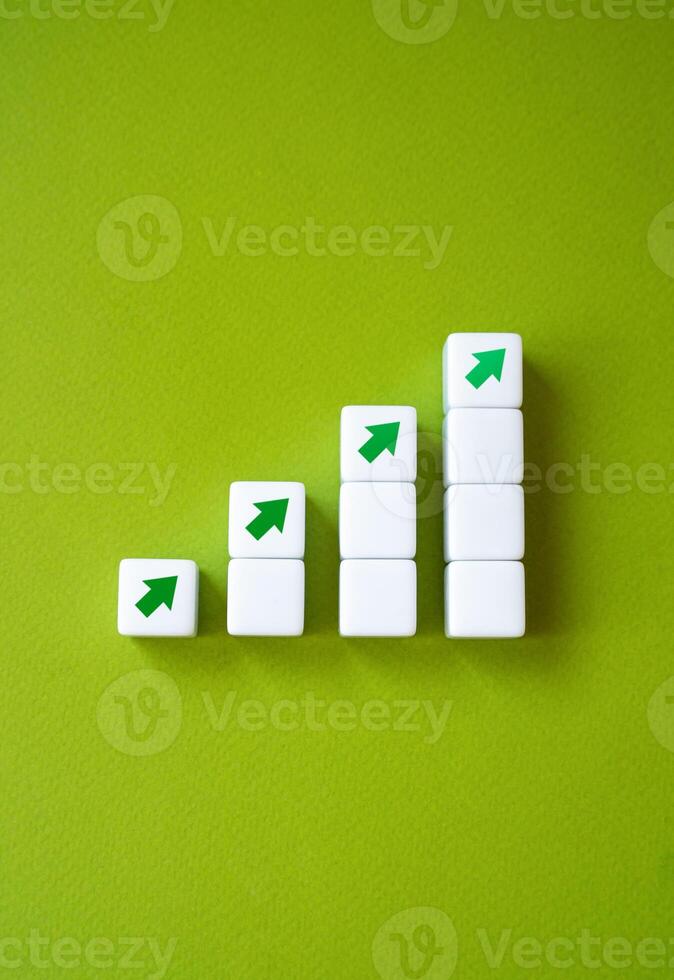 Growing graph made of blocks and up arrows. Steps of growth. Enlargement and growth concept. Career, economics. Statistics and news. Skills and self-development. photo