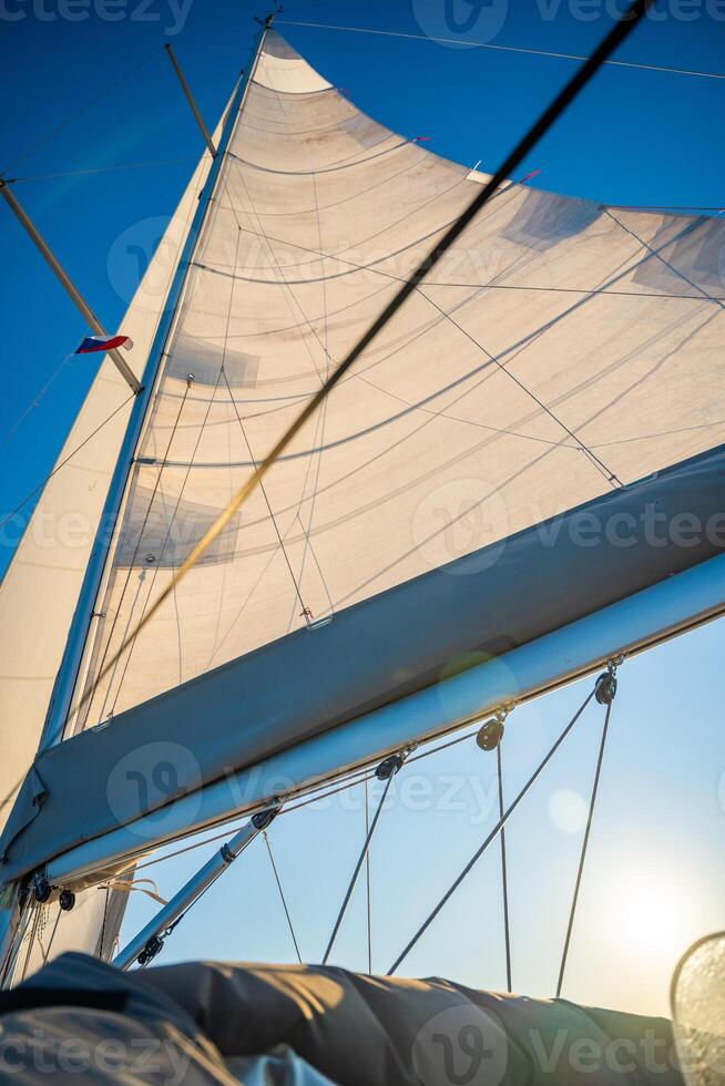 Sails of a sailing yacht in the wind sailing on the sea at sun light. High quality photo