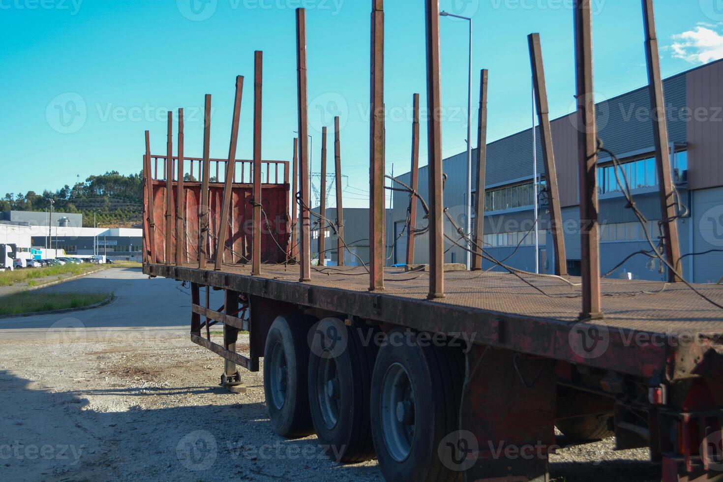 An empty timber truck stands in the middle of the forest. Forestry technologies - timber carrier for transporting logs. photo
