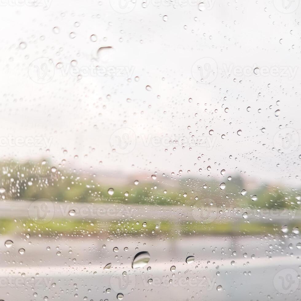 blurry window with dots of rain water for background photo