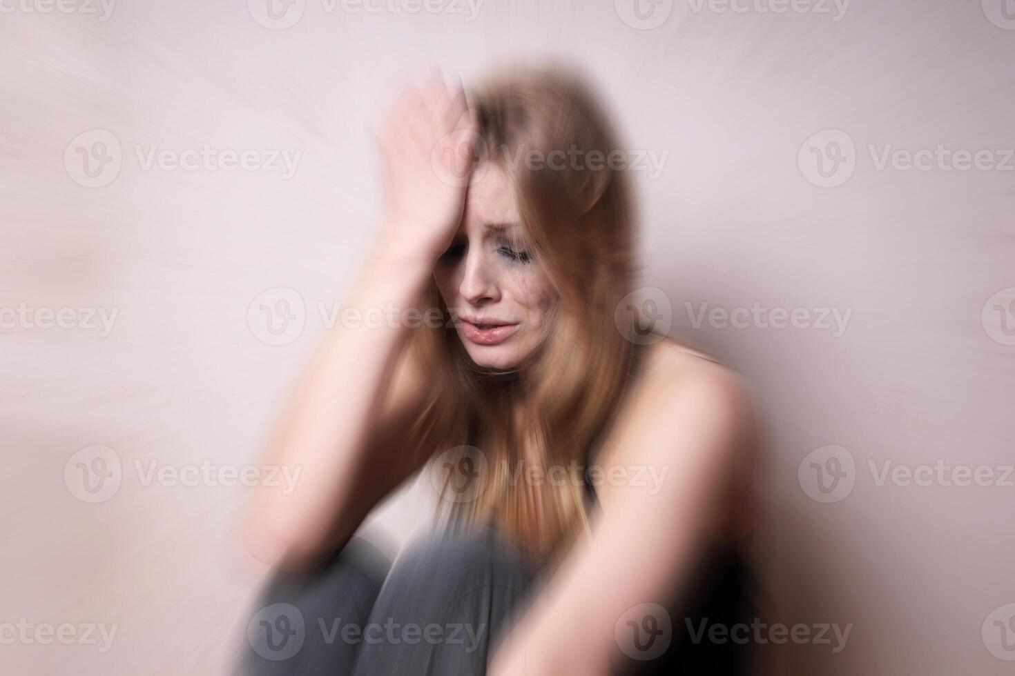 sad depressed young woman with tear-stained face photo