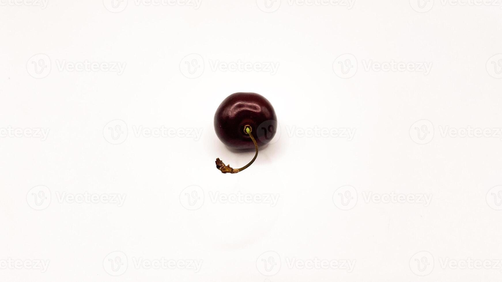 Fresh red cherry fruits on a plate on a white background in close-up. High quality photos