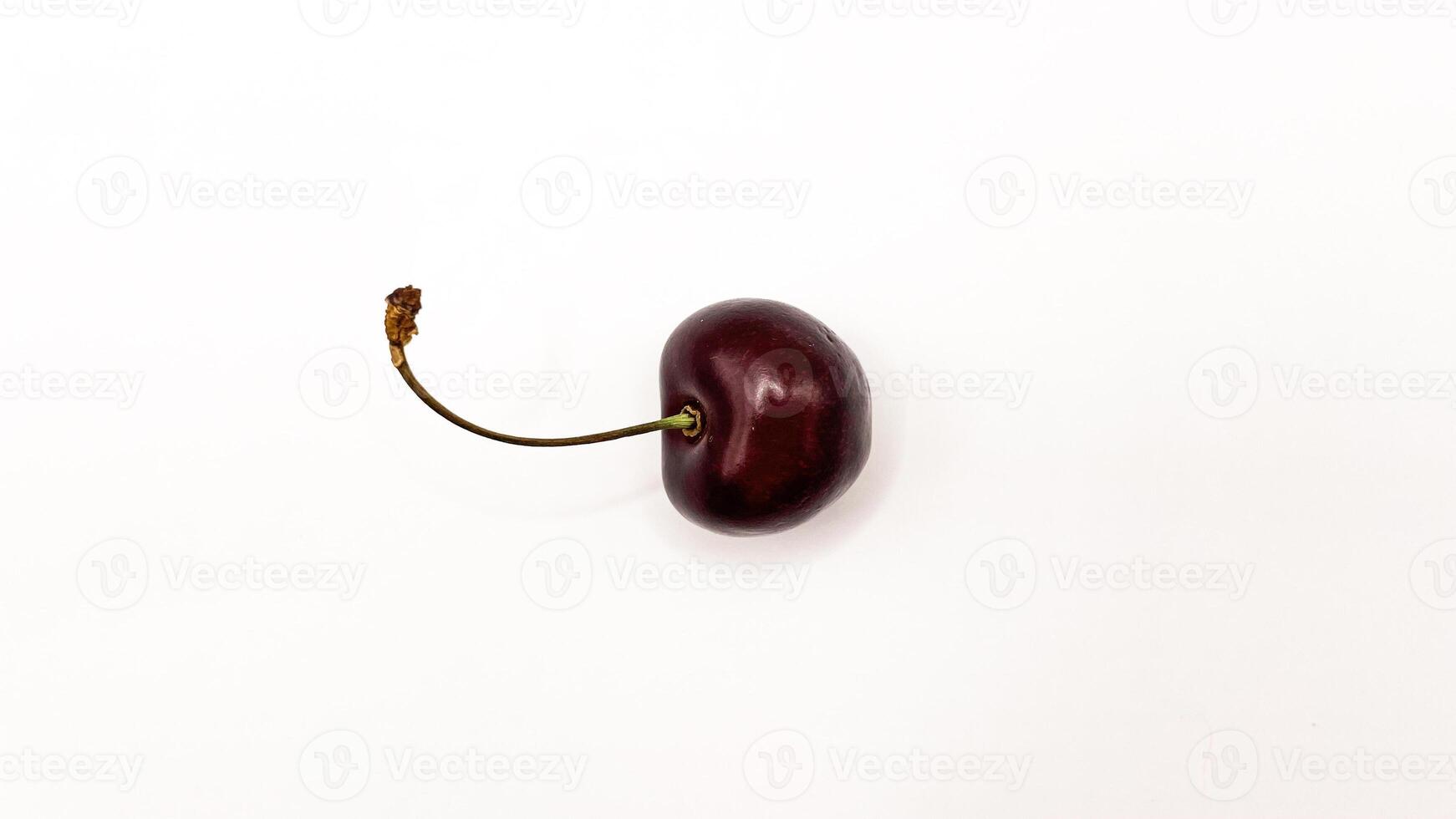 Fresh red cherry fruits on a plate on a white background in close-up. High quality photos