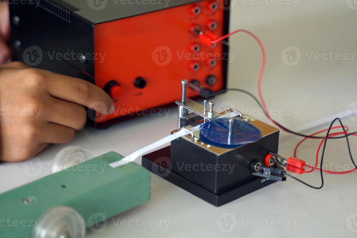 Science classroom, students are conducting a physics experiment on the speed of objects using a ticker timer device. Concept of science classroom, science skills, learning, science experiment. photo
