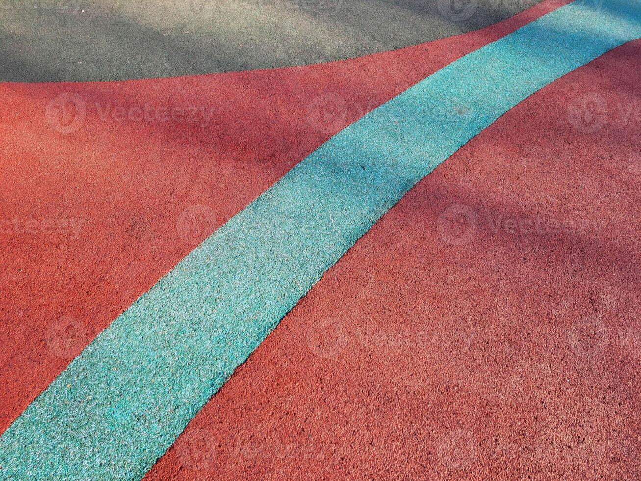 Colorful background of the rubber coating of the outdoor sports ground. View from above. photo