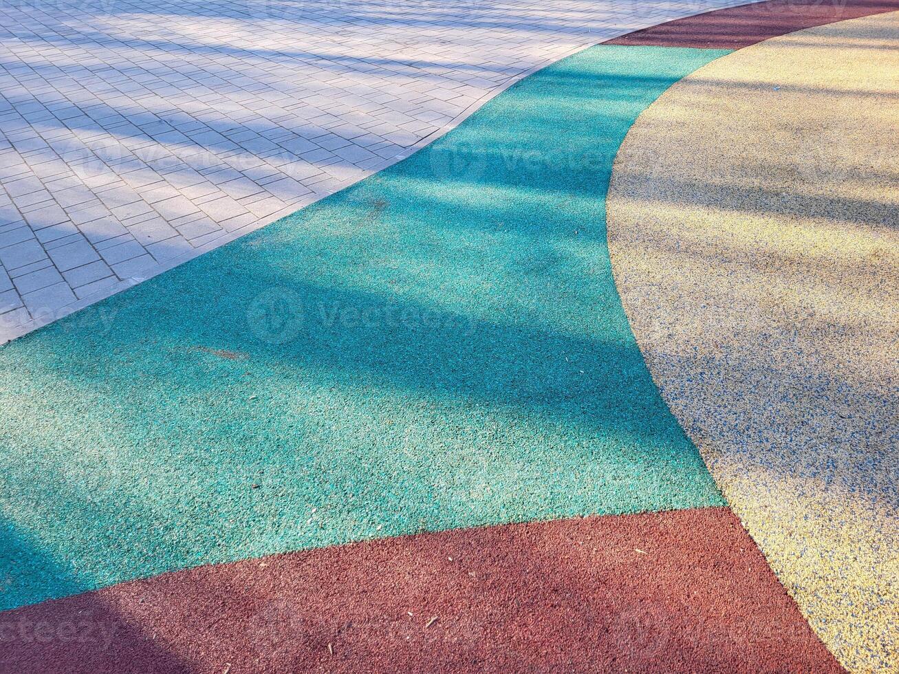 Colorful background of the rubber coating of the outdoor sports ground. View from above photo