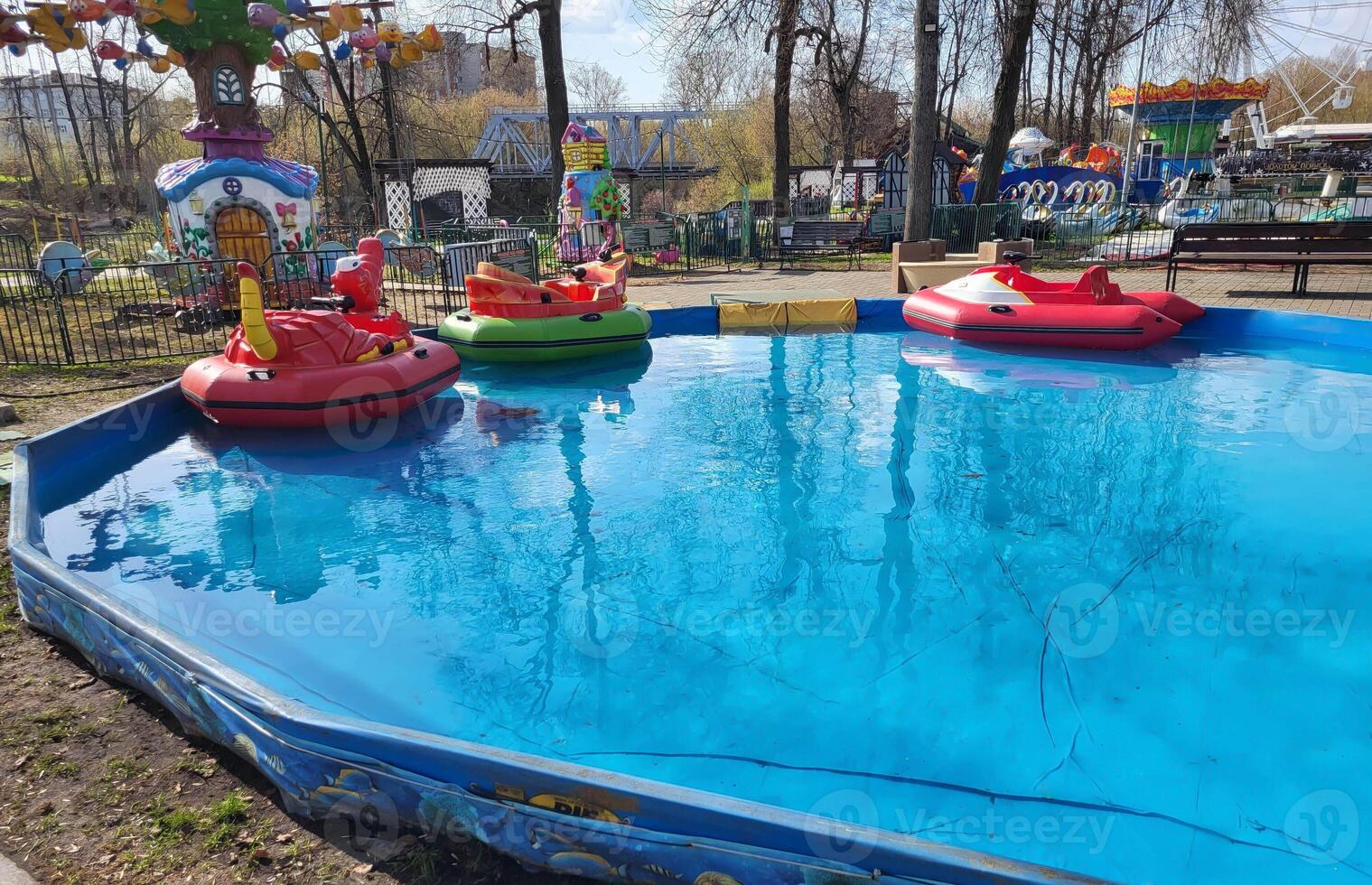 A small children's pool in a children's amusement park with a boat attraction. photo
