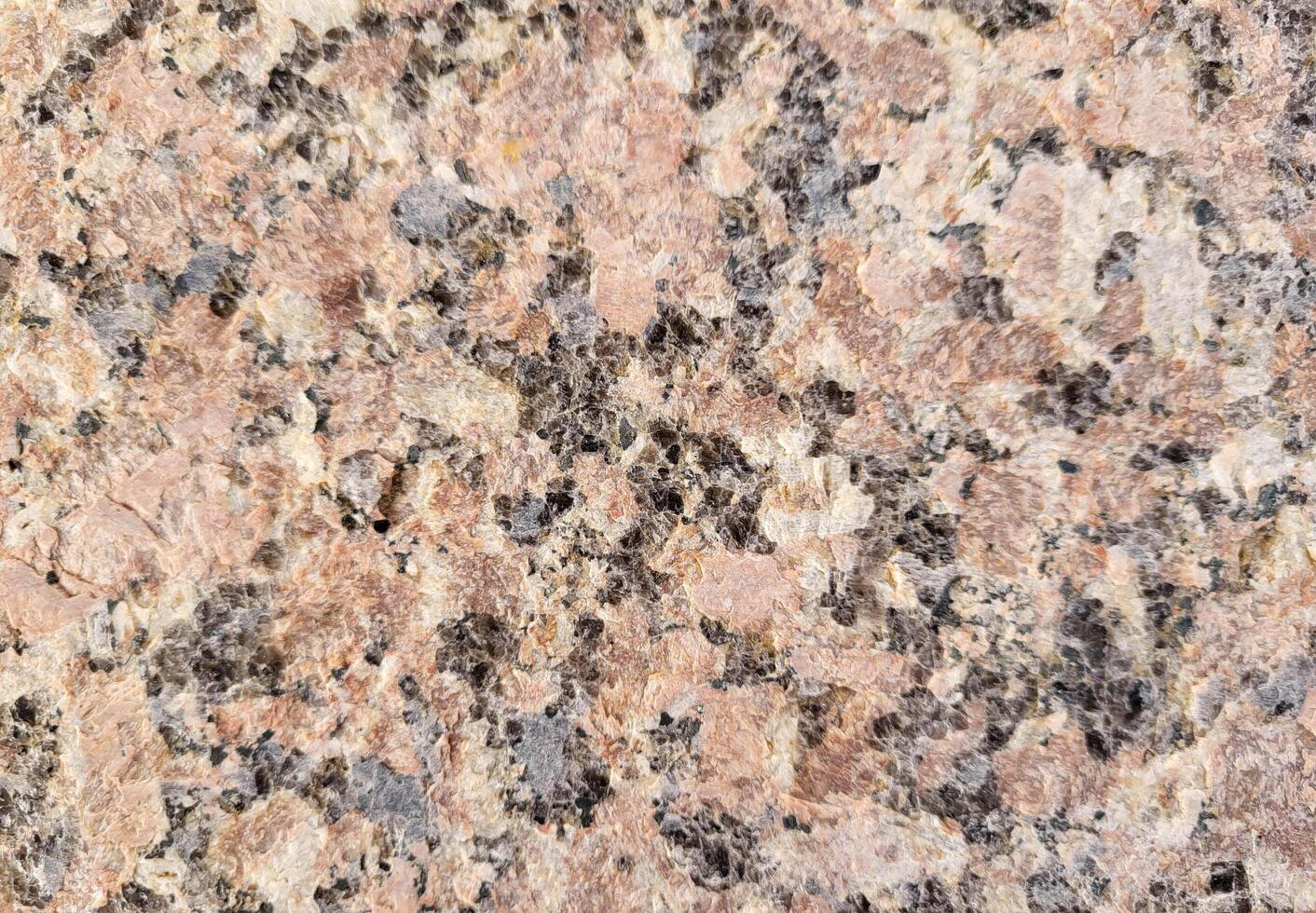 Close-up of the facade of the building, lined with pink marble slabs. Paving slabs in daylight. Natural colors. photo