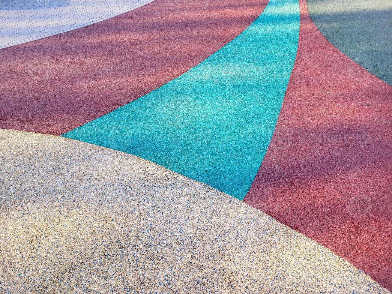 Colorful background of the rubber coating of the outdoor sports ground. View from above photo