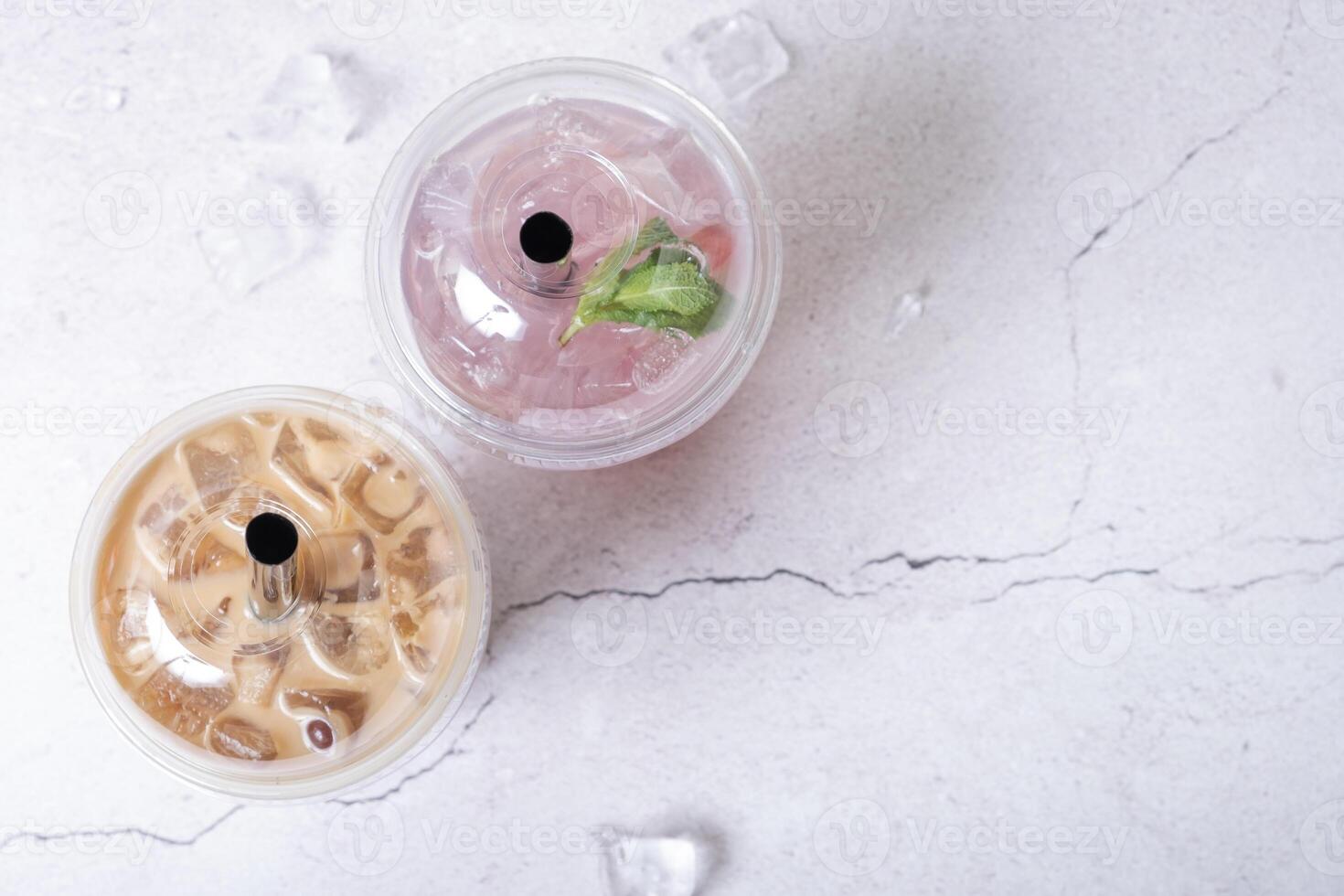 Two plastic glasses with ice bubble tea. Trendy summer drink with tapioca bubbles photo
