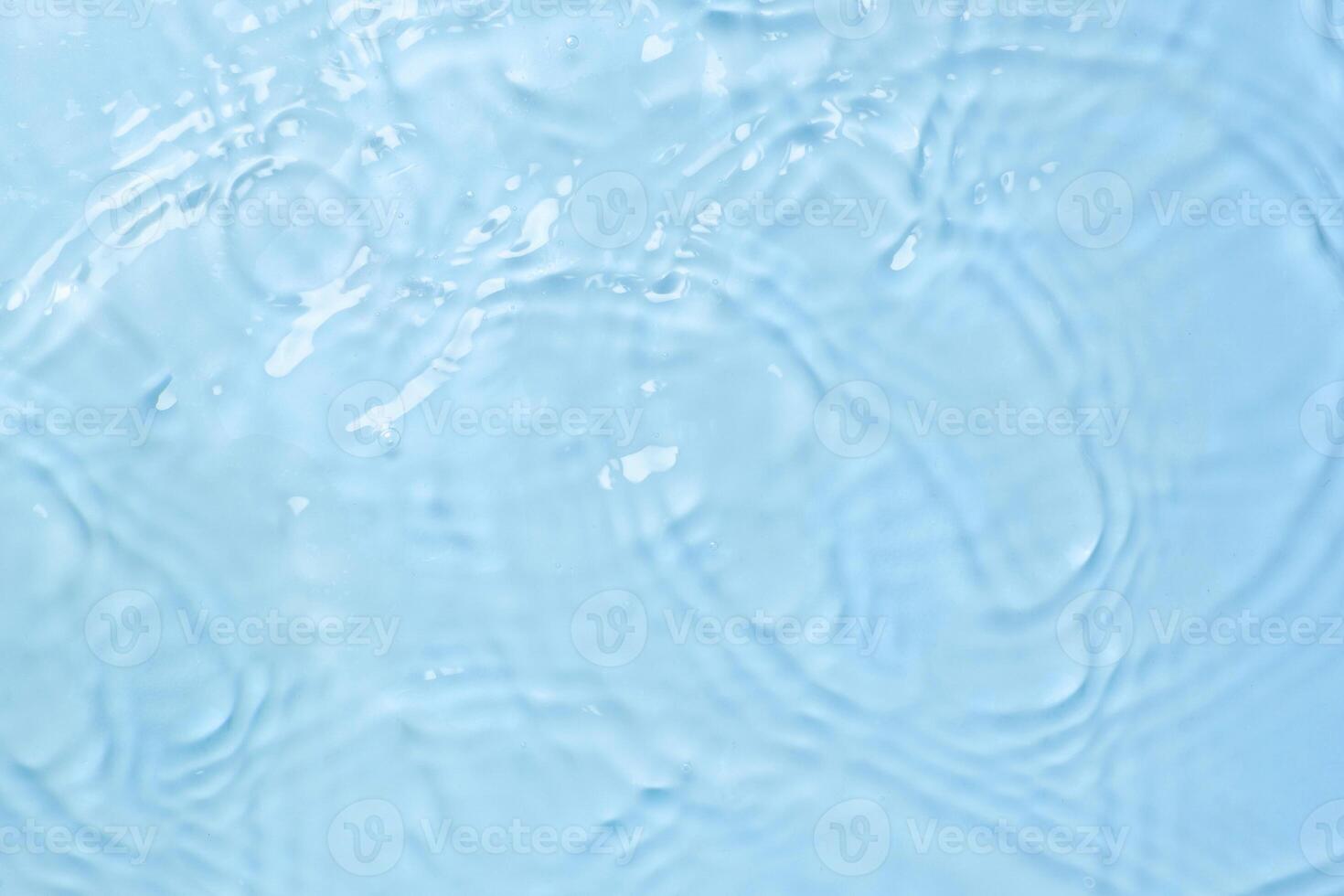 Blue water background with waves and drops top view photo