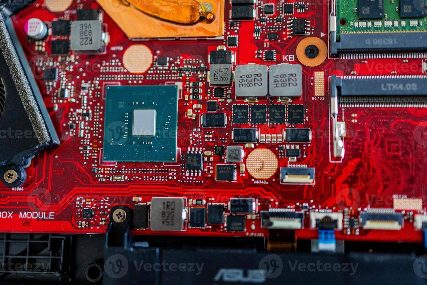 a motherboard with intricate circuit patterns, RAM modules, and various electronic components photo