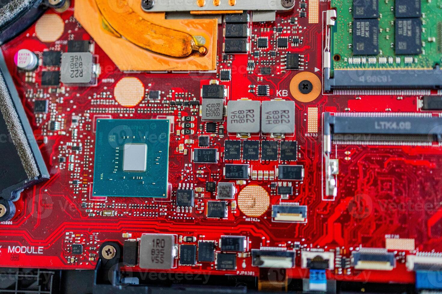 a motherboard with intricate circuit patterns, RAM modules, and various electronic components photo