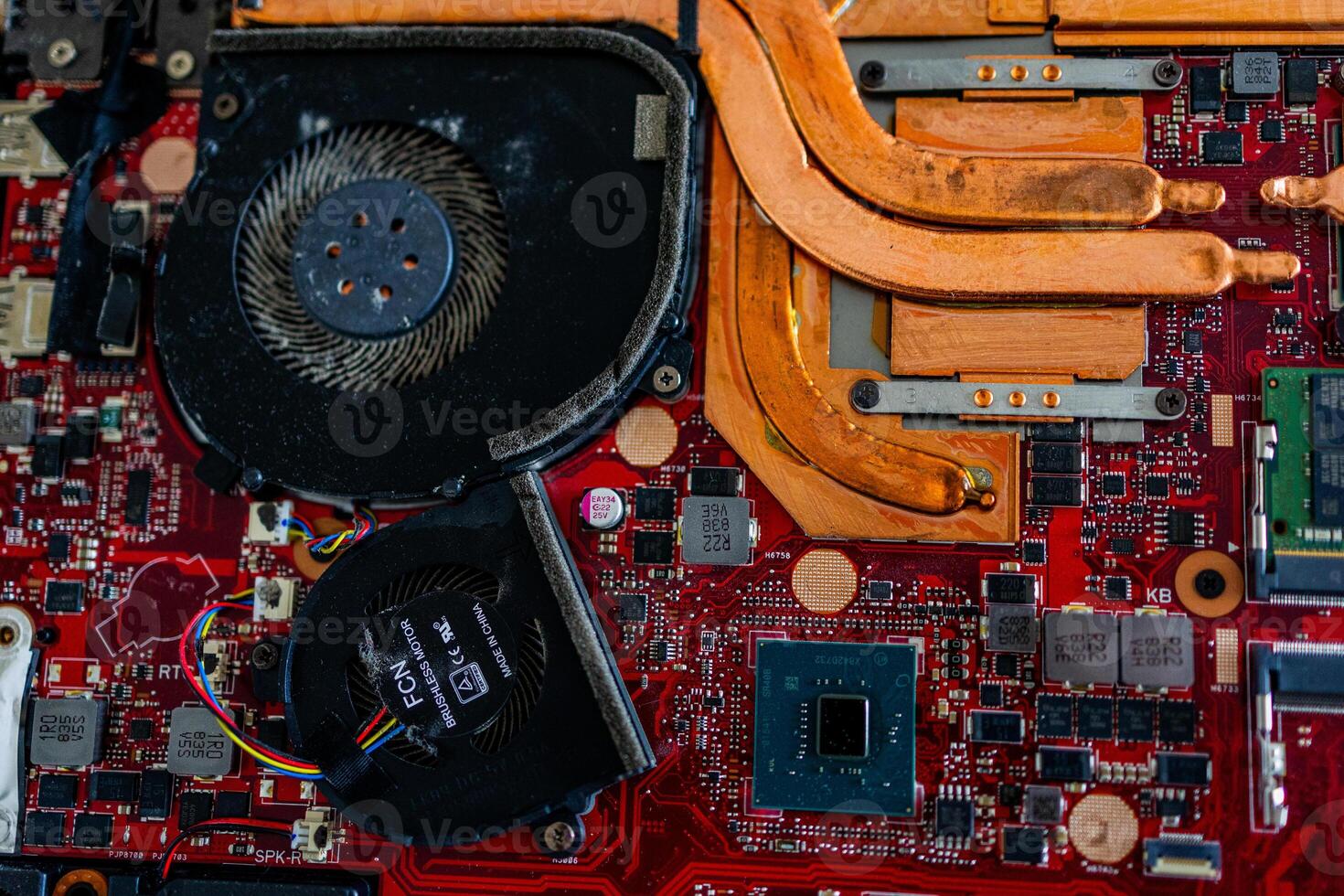 a motherboard with intricate circuit patterns, RAM modules, and various electronic components photo