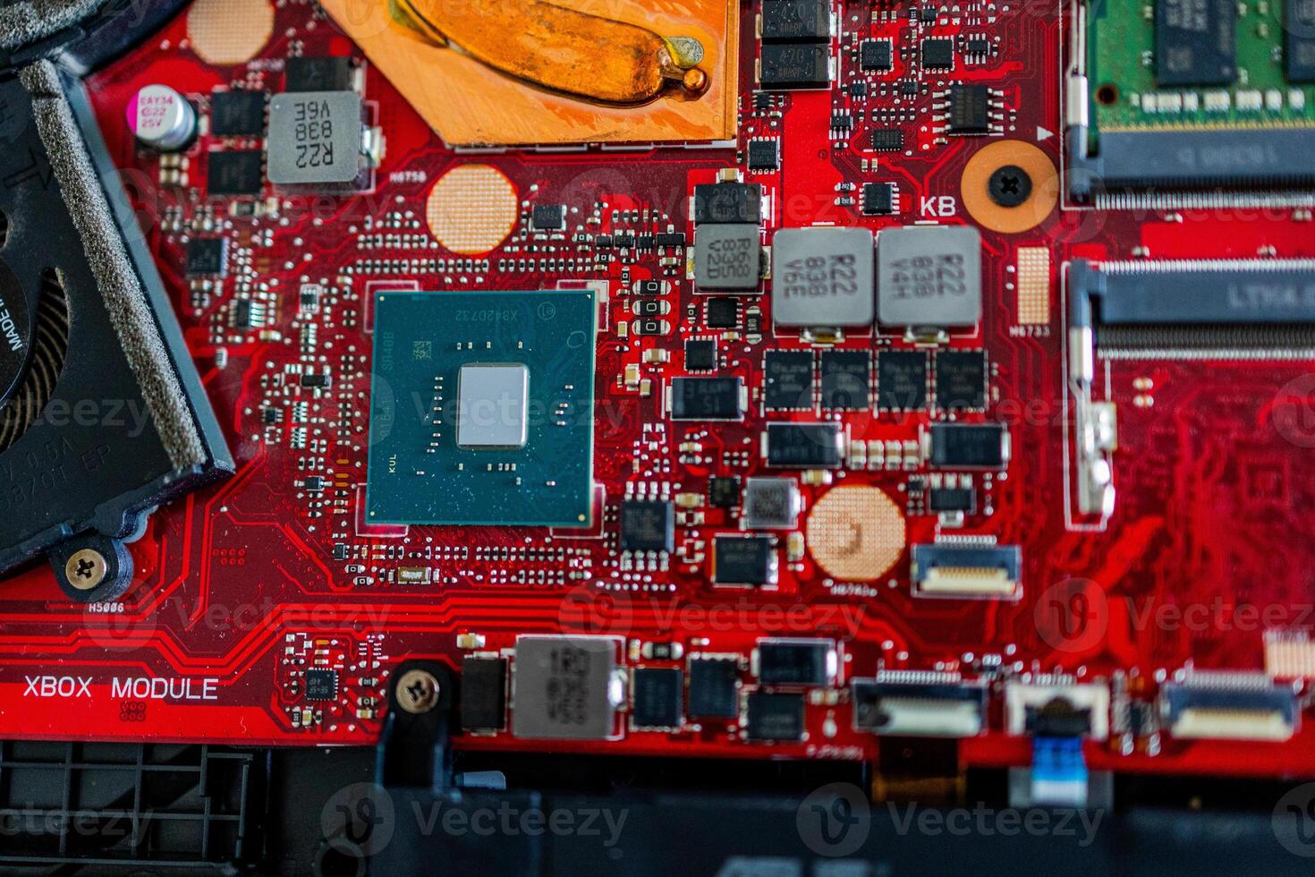a motherboard with intricate circuit patterns, RAM modules, and various electronic components photo