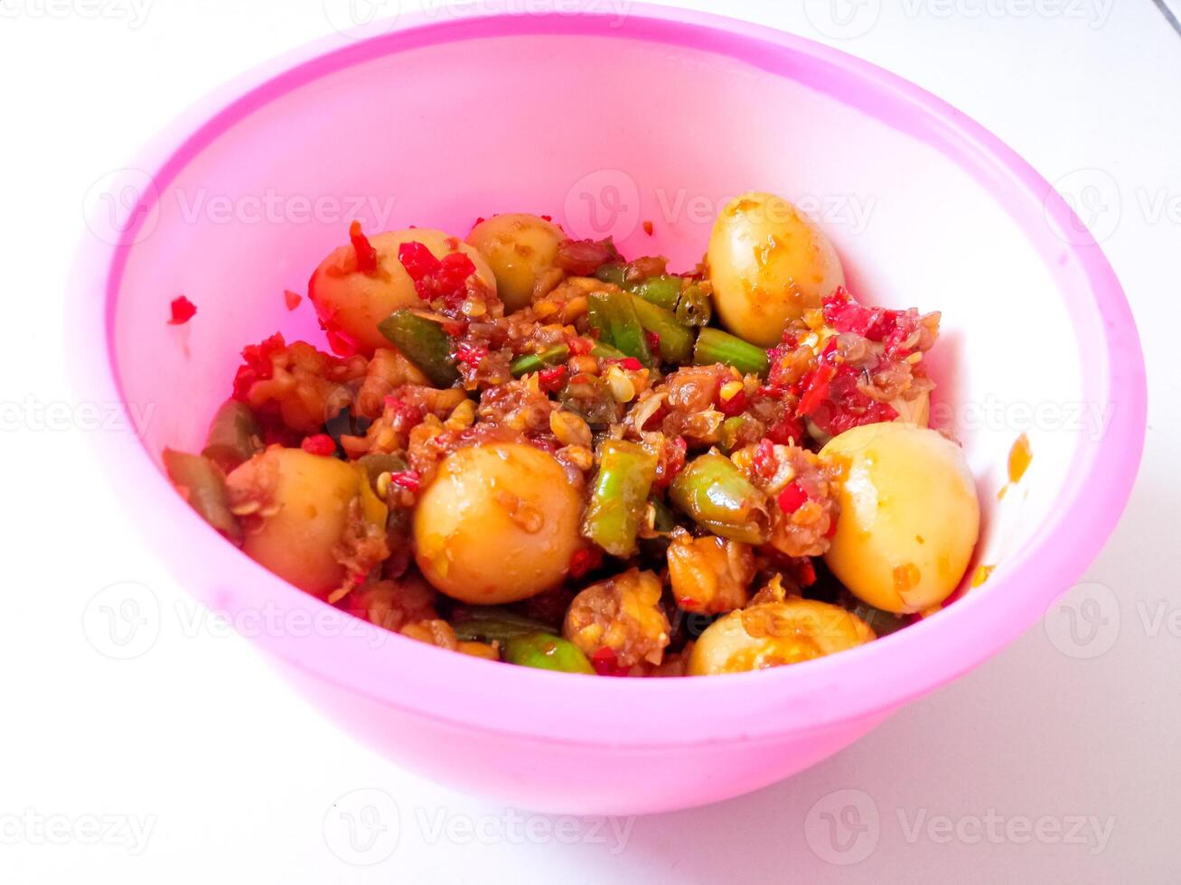 a bowl of balado quail eggs and tempeh ready to eat isolate on white photo