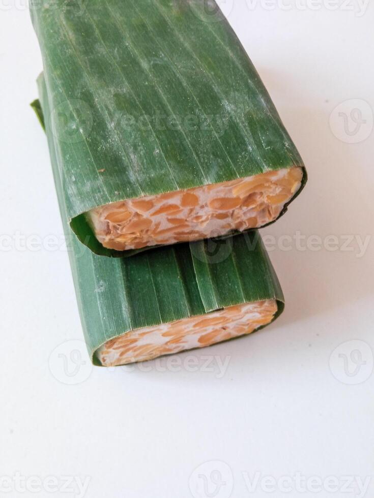 tempeh wrapped in banana leaves isolate on white photo