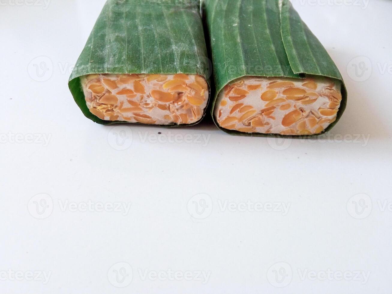 tempeh wrapped in banana leaves isolate on white photo