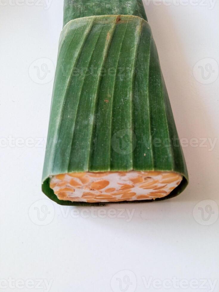 tempeh wrapped in banana leaves isolate on white photo