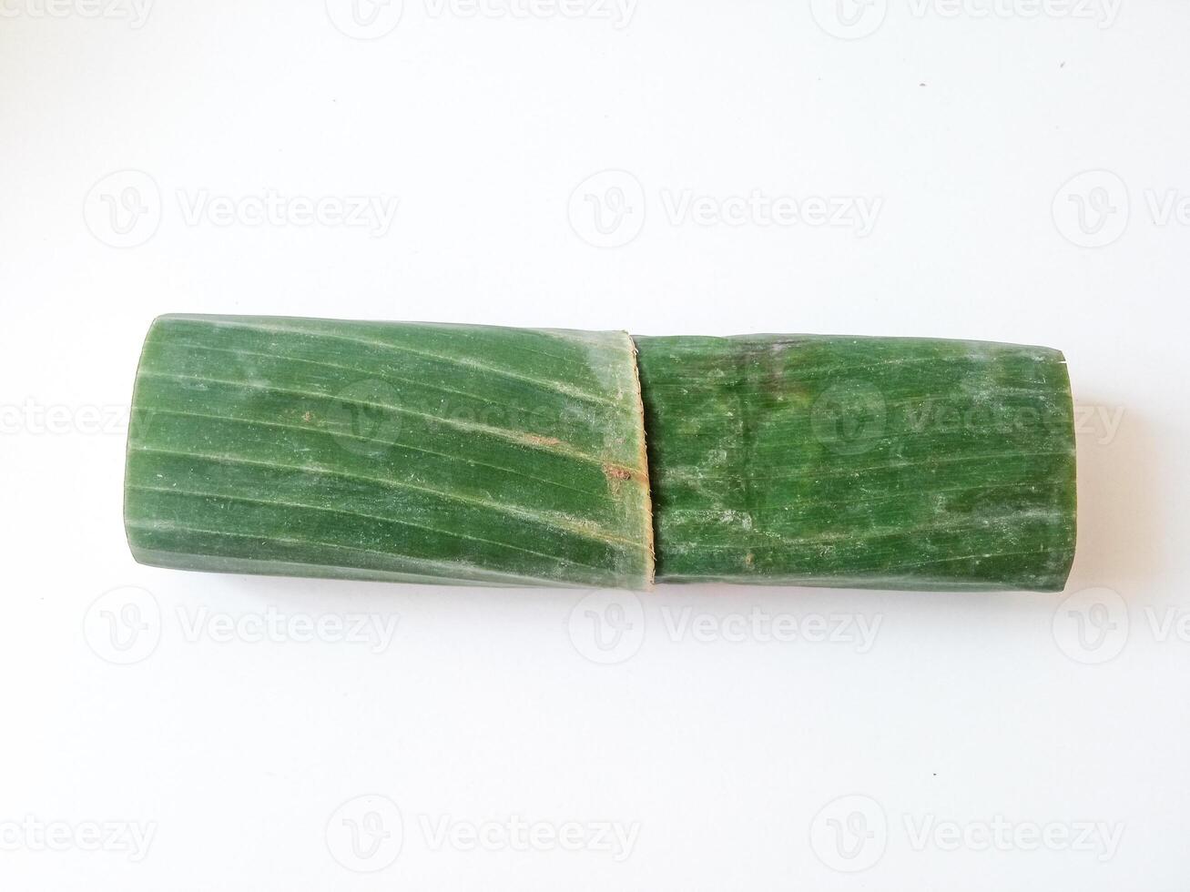 tempeh wrapped in banana leaves isolate on white photo