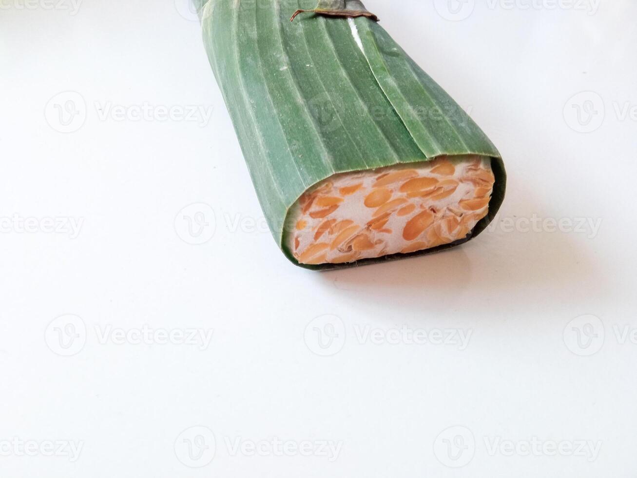 tempeh wrapped in banana leaves isolate on white photo