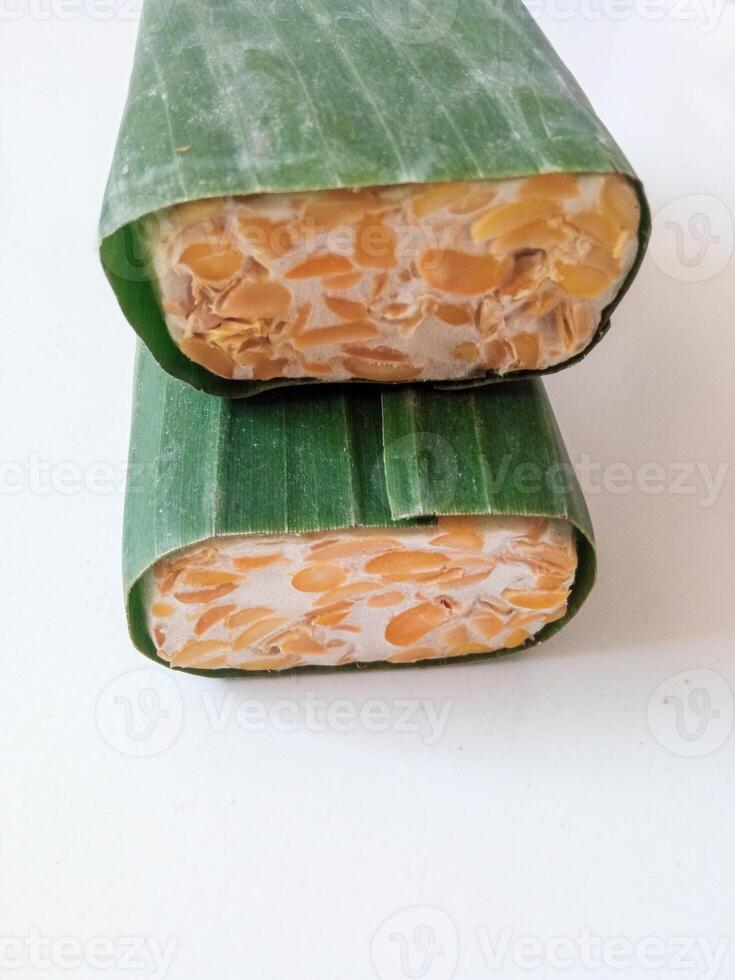 tempeh wrapped in banana leaves isolate on white photo