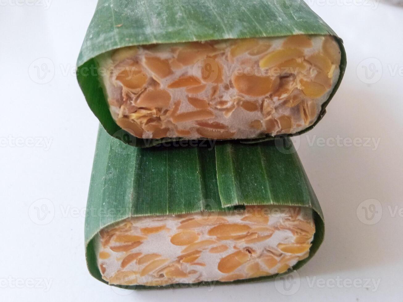 tempeh wrapped in banana leaves isolate on white photo
