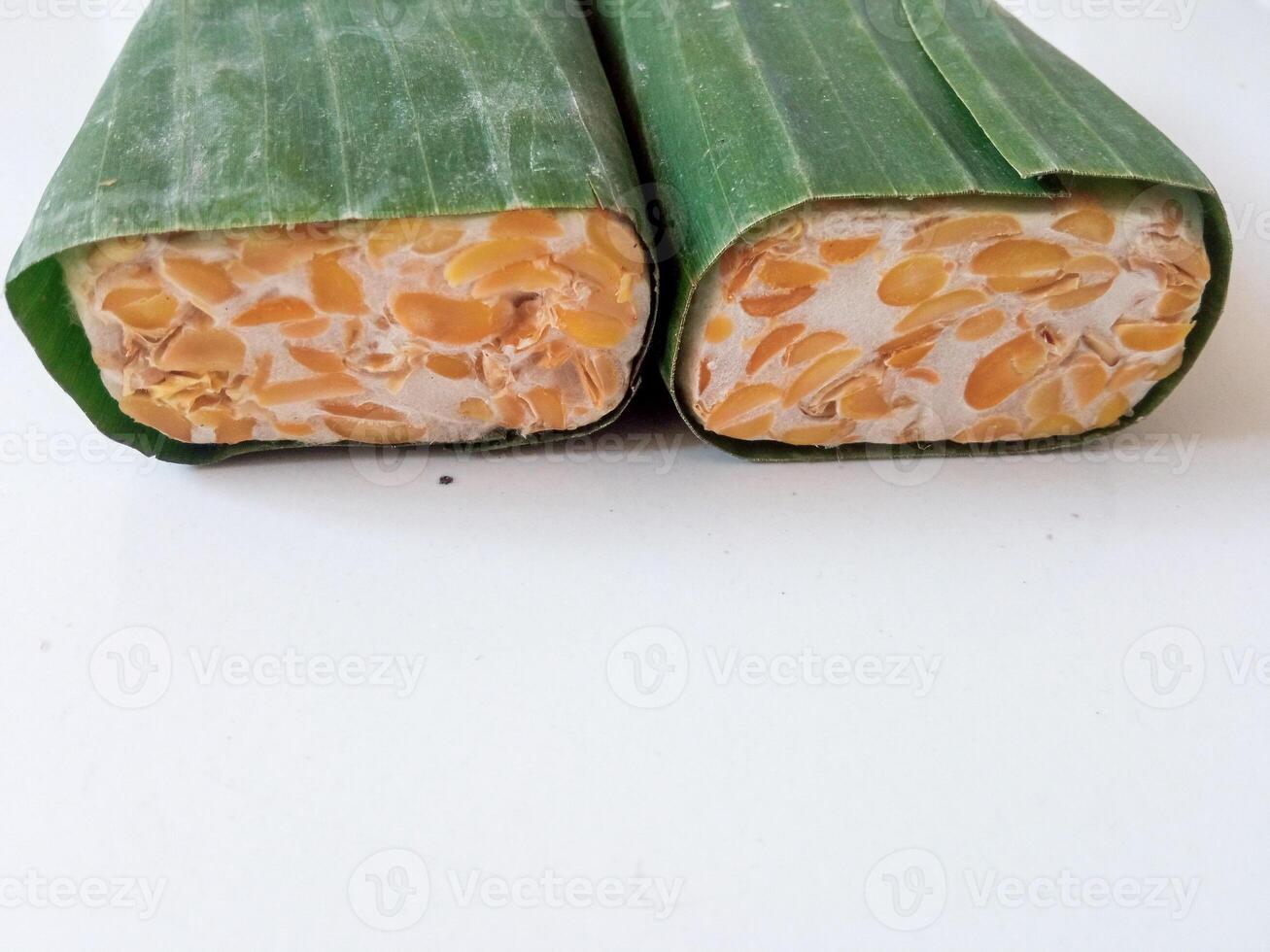 tempeh wrapped in banana leaves isolate on white photo