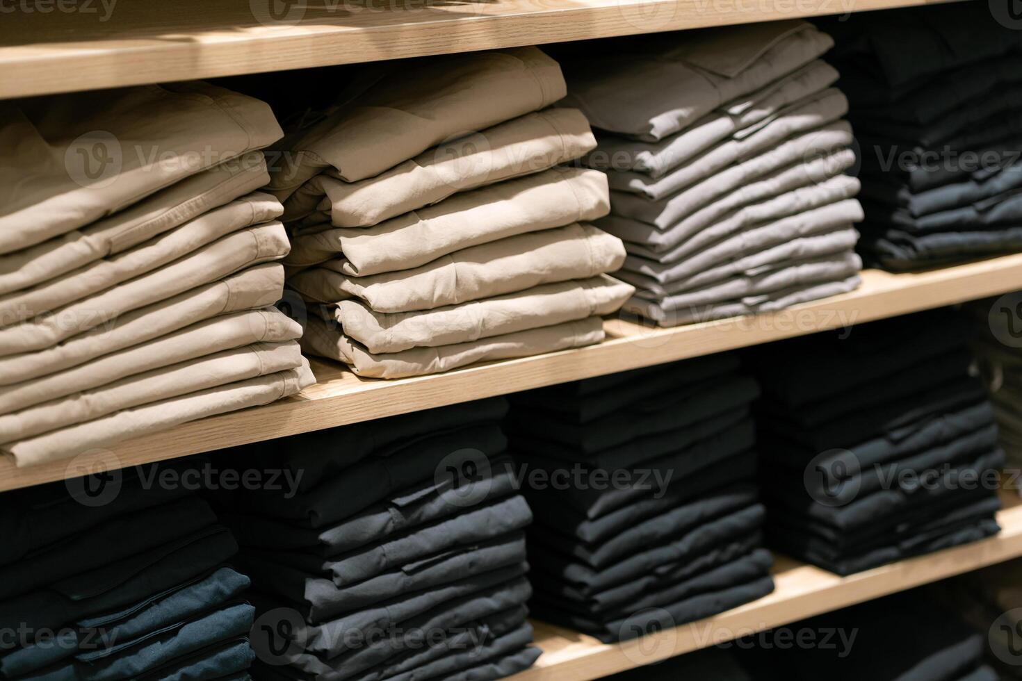 Stack of cotton colorful clothes on table in cloth store. photo