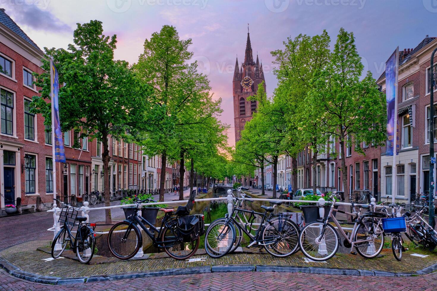Delft street with bicycles on bridge over canal photo