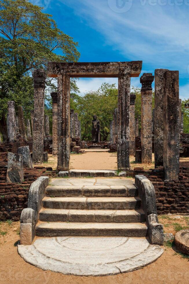 Stainding Buddha statue in ancient ruins photo