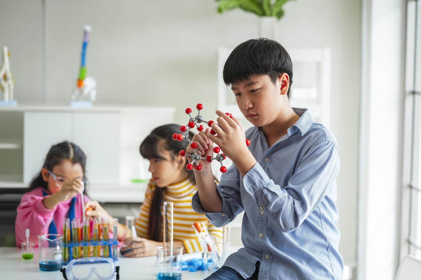 children boy using vr learning molecular structure in science laboratory photo