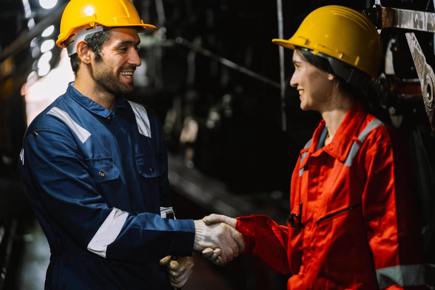 man and a woman shake hands in a factory photo