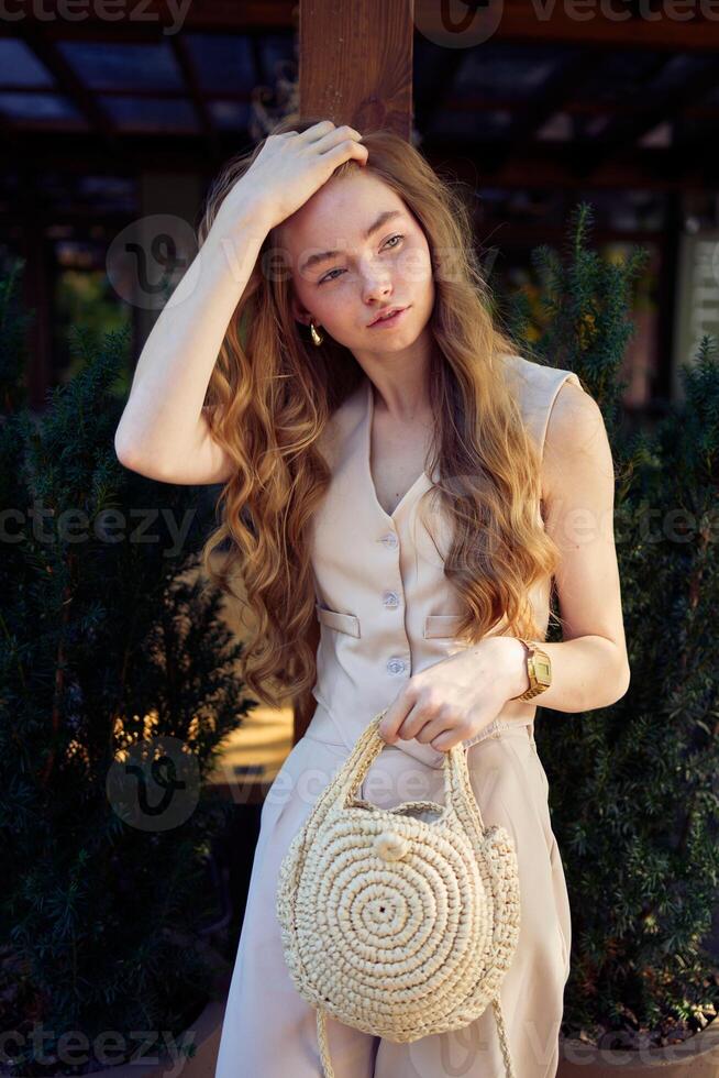 a beautiful teenage girl in a peach fuzz suit with a vest, in the old money style in a fancy restaurant photo