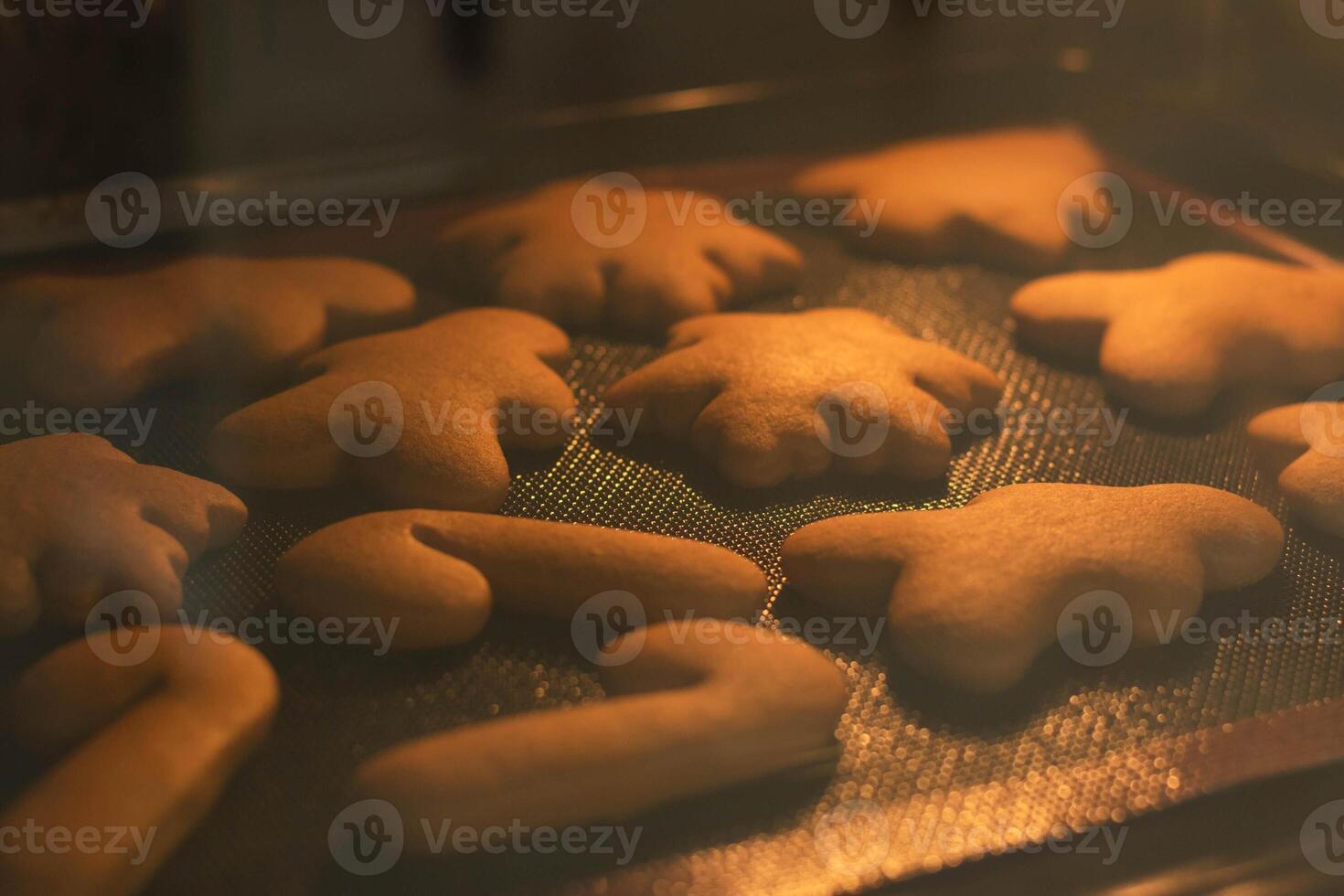 New Year's traditional cookies snowflakes gingerbread man baked in oven. Preparing for Christmas photo
