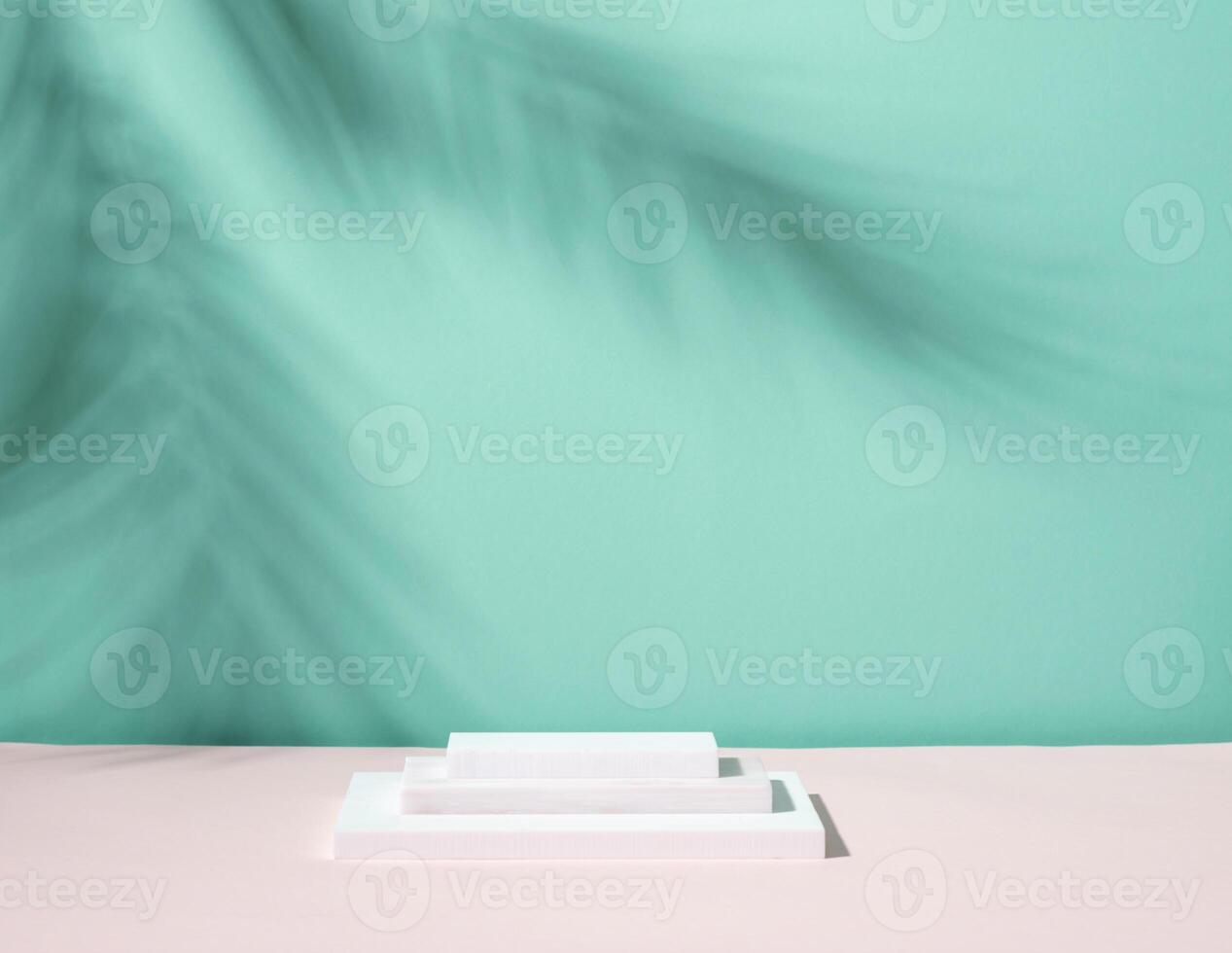 Abstract podium pedestal from white marble, blue menthol empty background deep shadows from plant photo