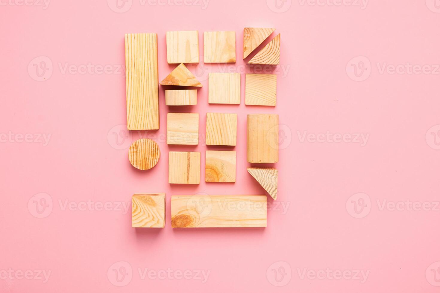 Wooden cubes lie in a row on pink background. The concept of using environmentally friendly natural materials Zero West. photo