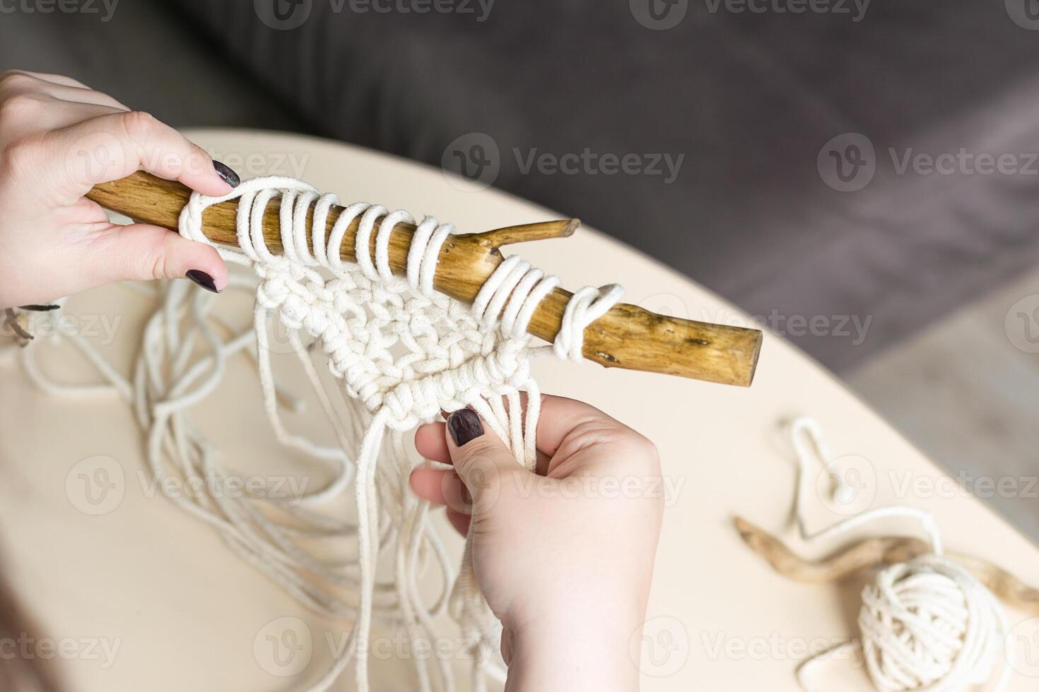 Female hands weave macrame the home workshop. Boho lifestyle. Hobby concept photo